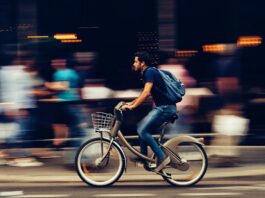 man riding bicycle on city street 310983 scaled
