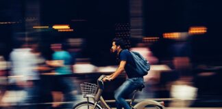 man riding bicycle on city street 310983 scaled