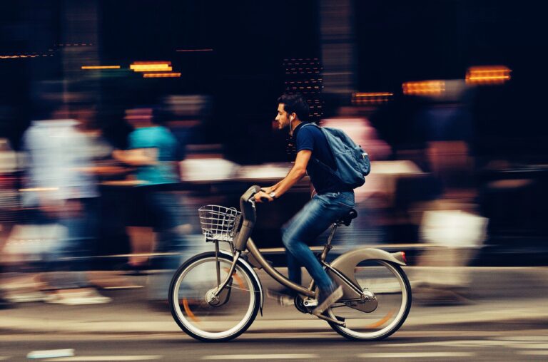 man riding bicycle on city street 310983 scaled