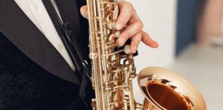 person holding brass saxophone 3984800 scaled