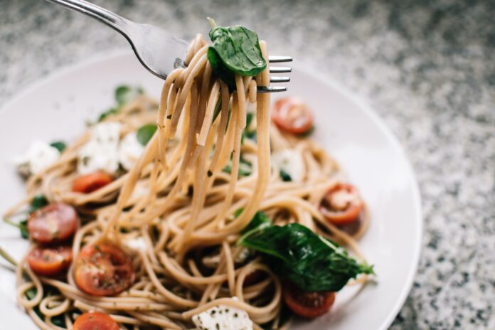 selective focus photography of pasta with tomato and basil 1279330 scaled